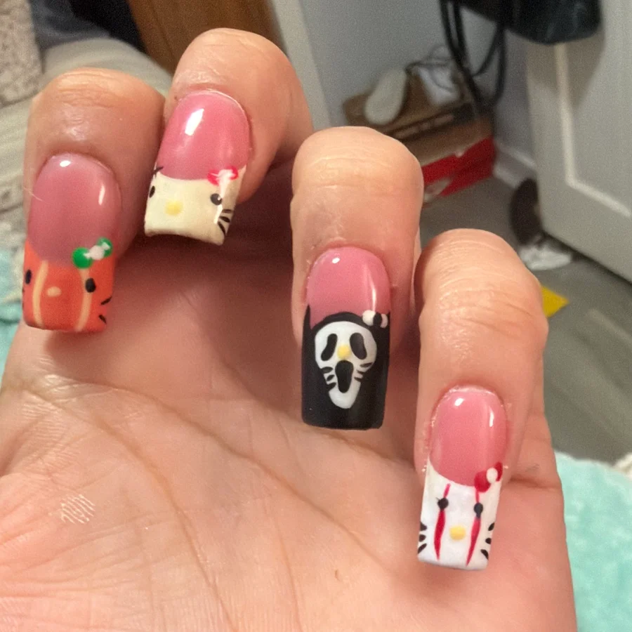 Hand-painted Halloween nails with a pumpkin, ghost mask and kitty French tips