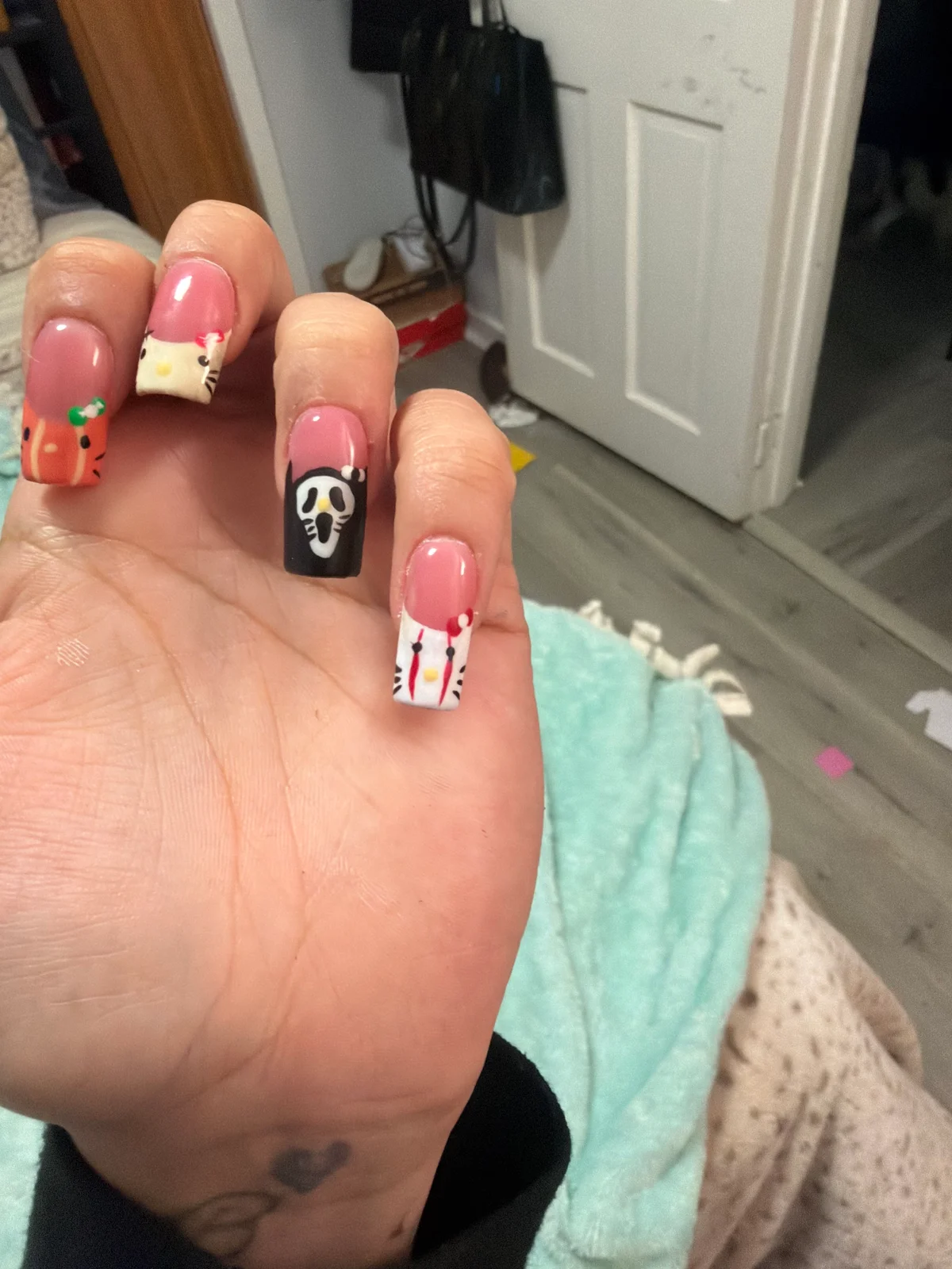 Hand-painted Halloween nails with a pumpkin, ghost mask and kitty French tips